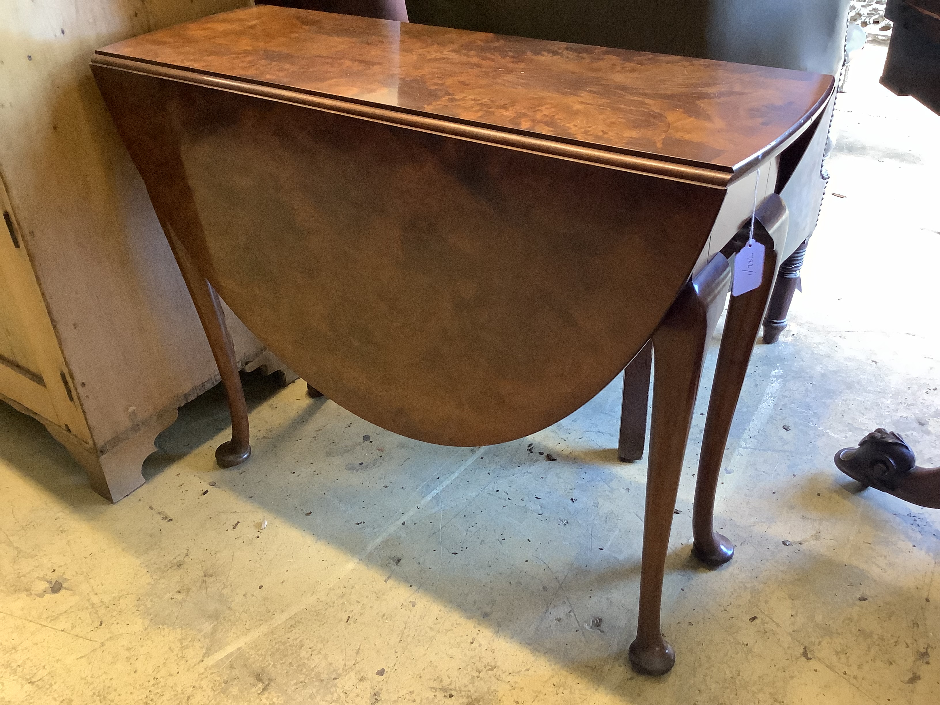 A Queen Anne style figured walnut oval pad foot drop leaf dining table, width 90cm, length 120cm extended, height 73cm